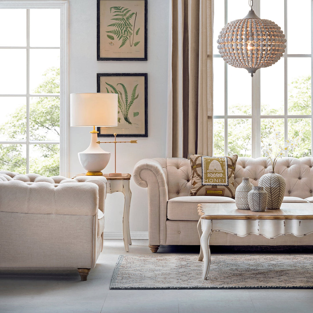 Loft Home Living Room Sofas Collection - Luxurious tufted beige sofa with vintage-style accents, paired with a matching coffee table and elegant decor in a bright living room setting