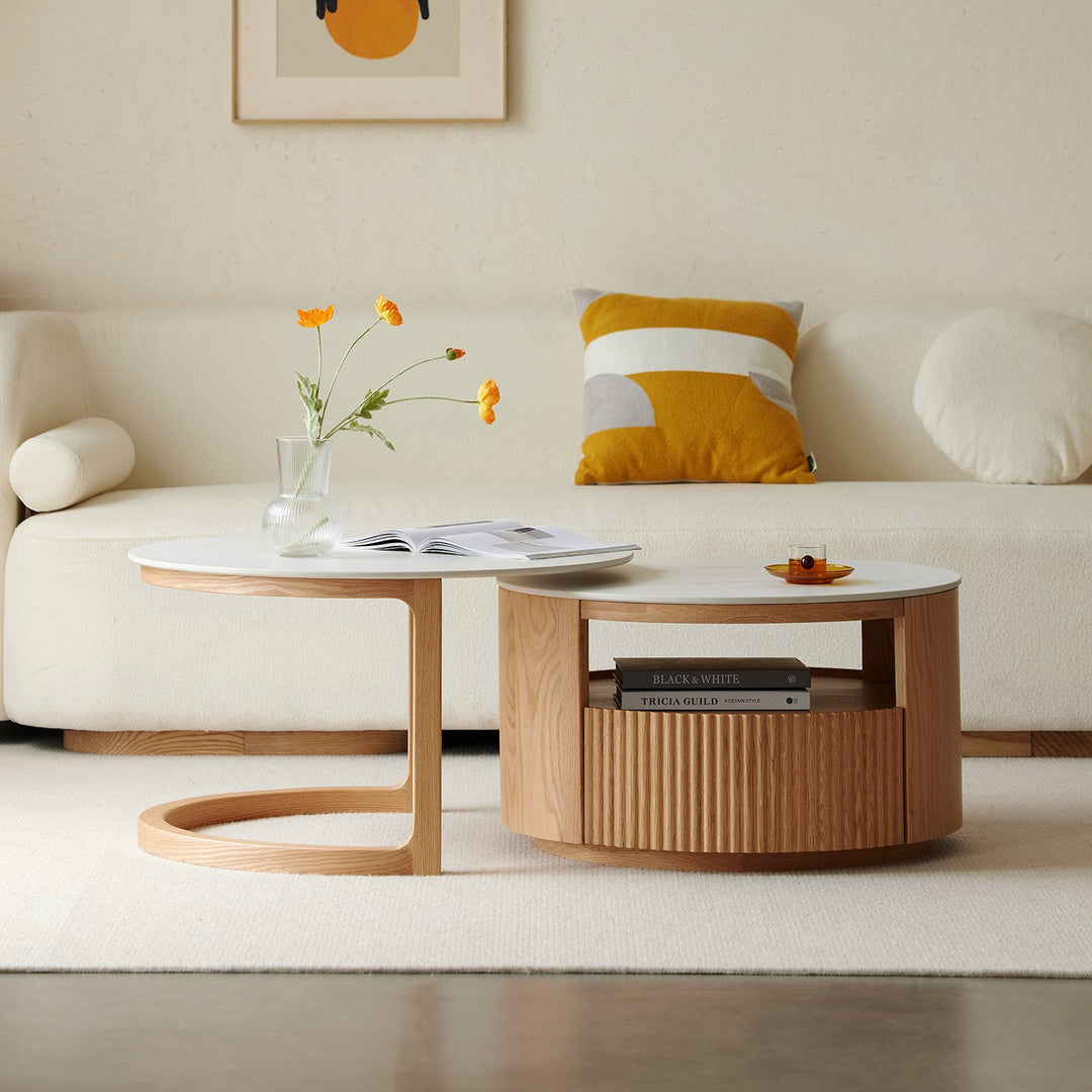 Elegant living room table with natural wood finish and white accents, styled alongside a modern cream sofa, yellow accent cushion, and minimalist decor