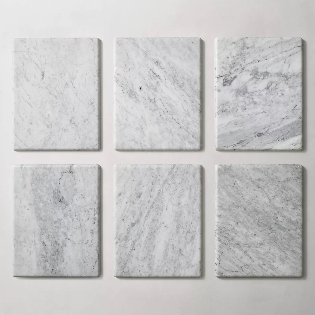 Set of six rectangular white marble slabs with natural grey veining, showcasing timeless elegance for table designs or decor.