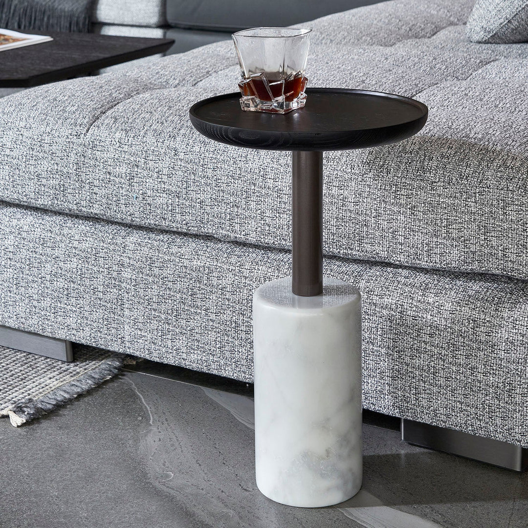 Minimalist marble side table with a cylindrical white marble base and sleek black top, perfectly complementing modern sofas and interiors.