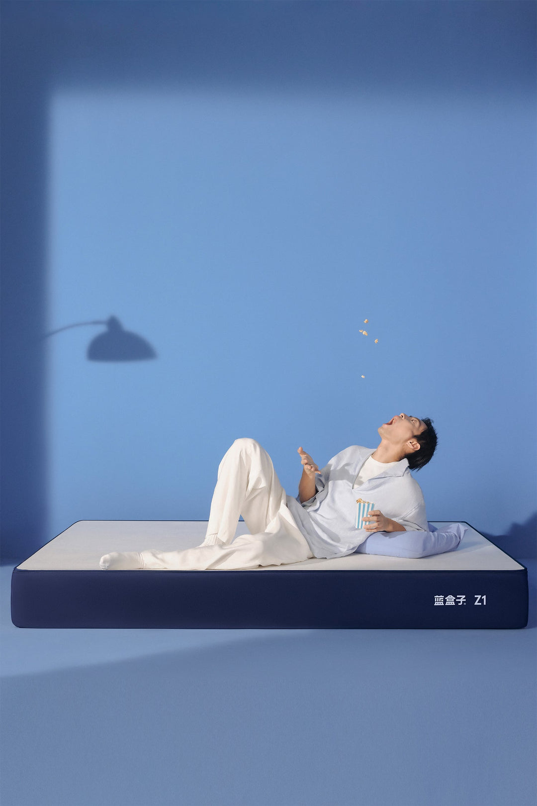 Blue Box Z1 mattress with a relaxed lifestyle scene, designed for comfortable sleep and modern bedrooms in Singapore.