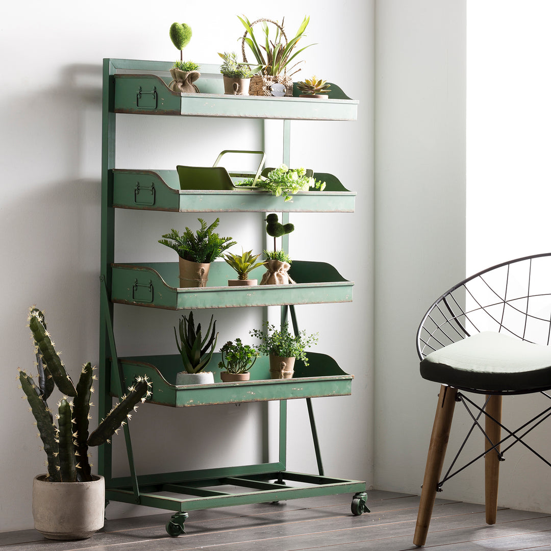 Green metal shelving unit filled with small potted plants and succulents, paired with a modern wire-frame chair, creating a fresh and minimalist indoor garden display.