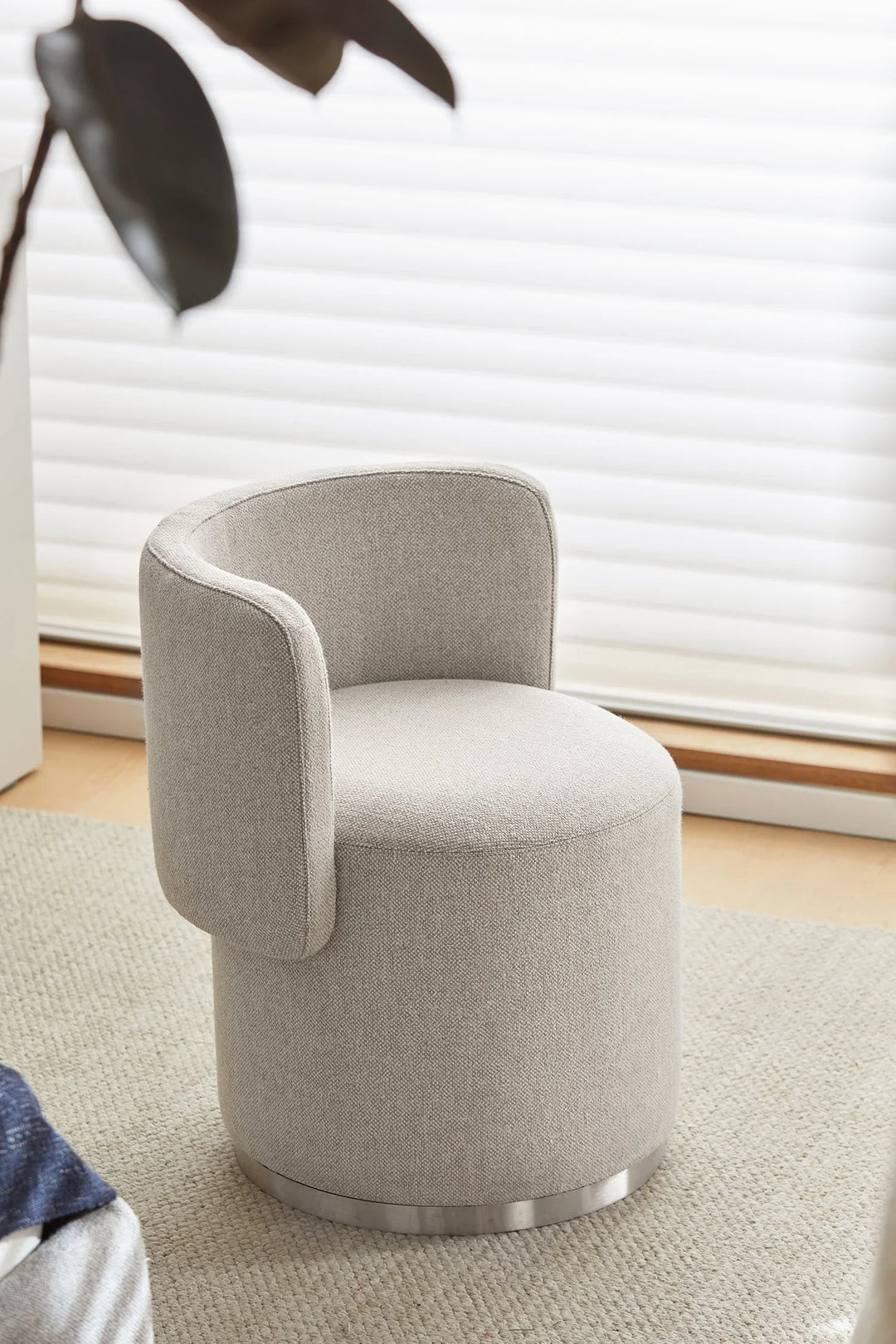 Minimalist premium fabric accent chair with rounded backrest and metal base, modern neutral design enhancing stylish comfort in Singapore living spaces.