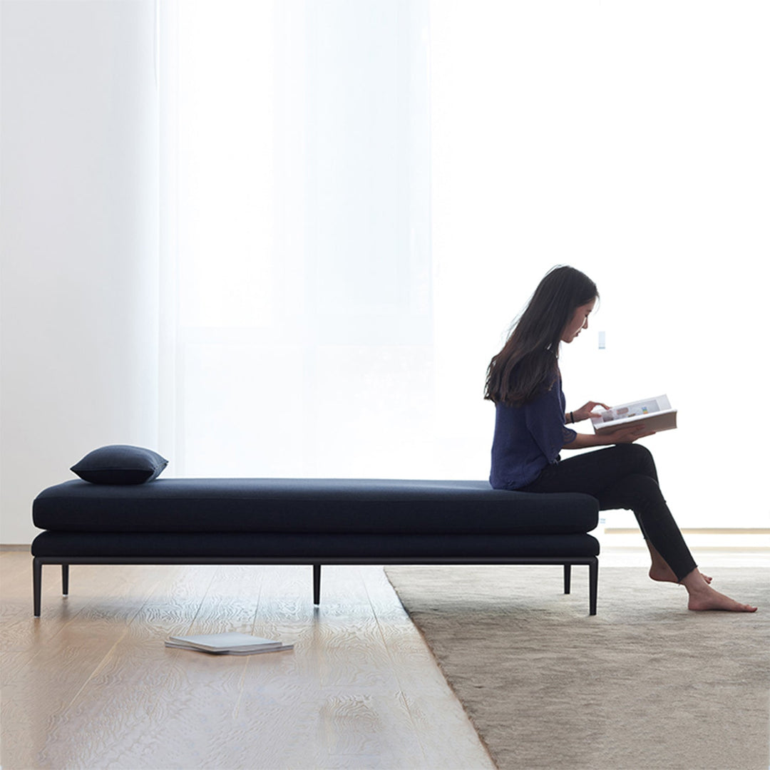 Loft Home minimalist sofa bed collection, featuring a sleek navy blue sofa bed with a modern design, paired with a serene reading space, ideal for compact and contemporary interiors.