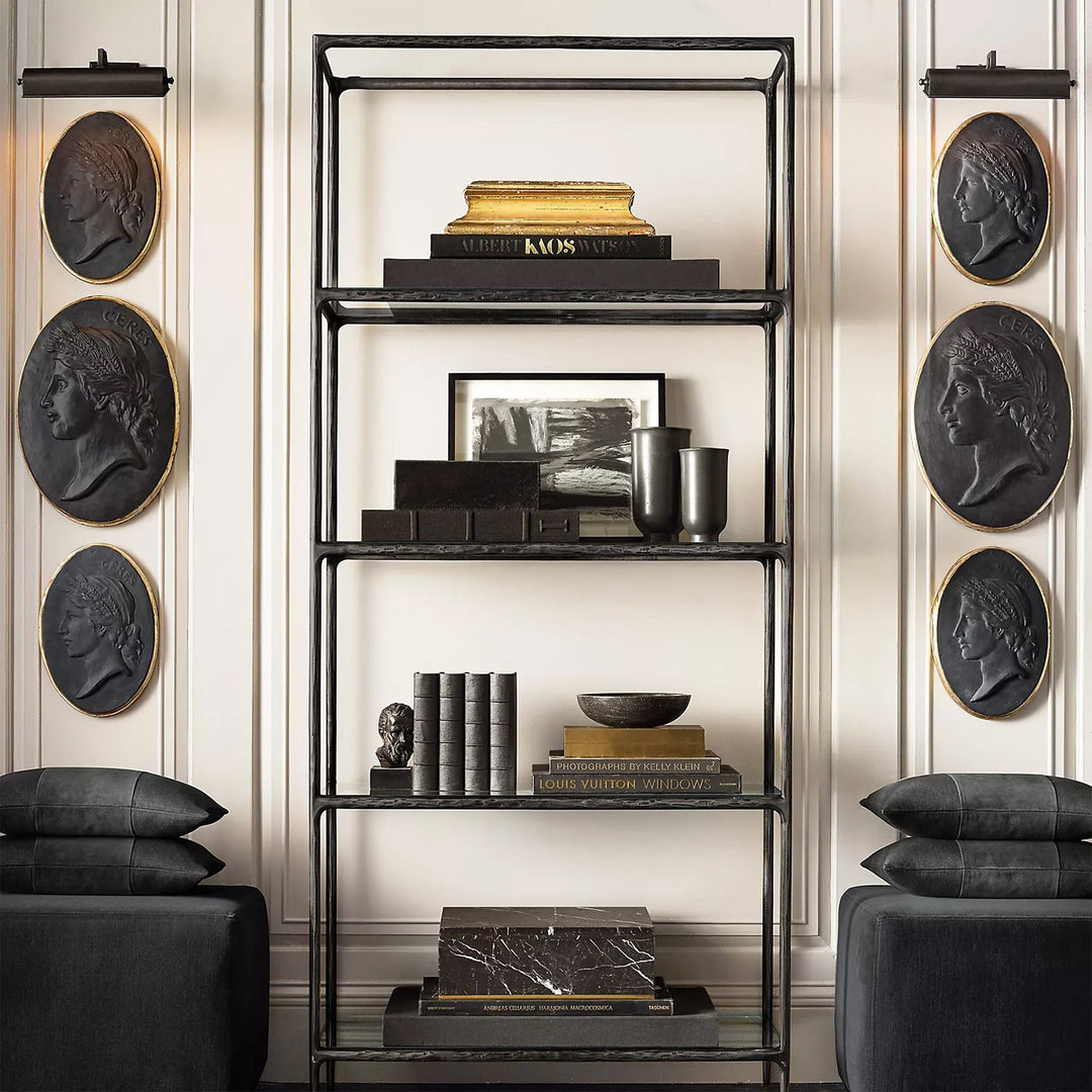 Loft Home Minimalist Storages – Elegant black metal shelf adorned with books and decor pieces, framed by classical wall plaques, enhancing modern interior styling.