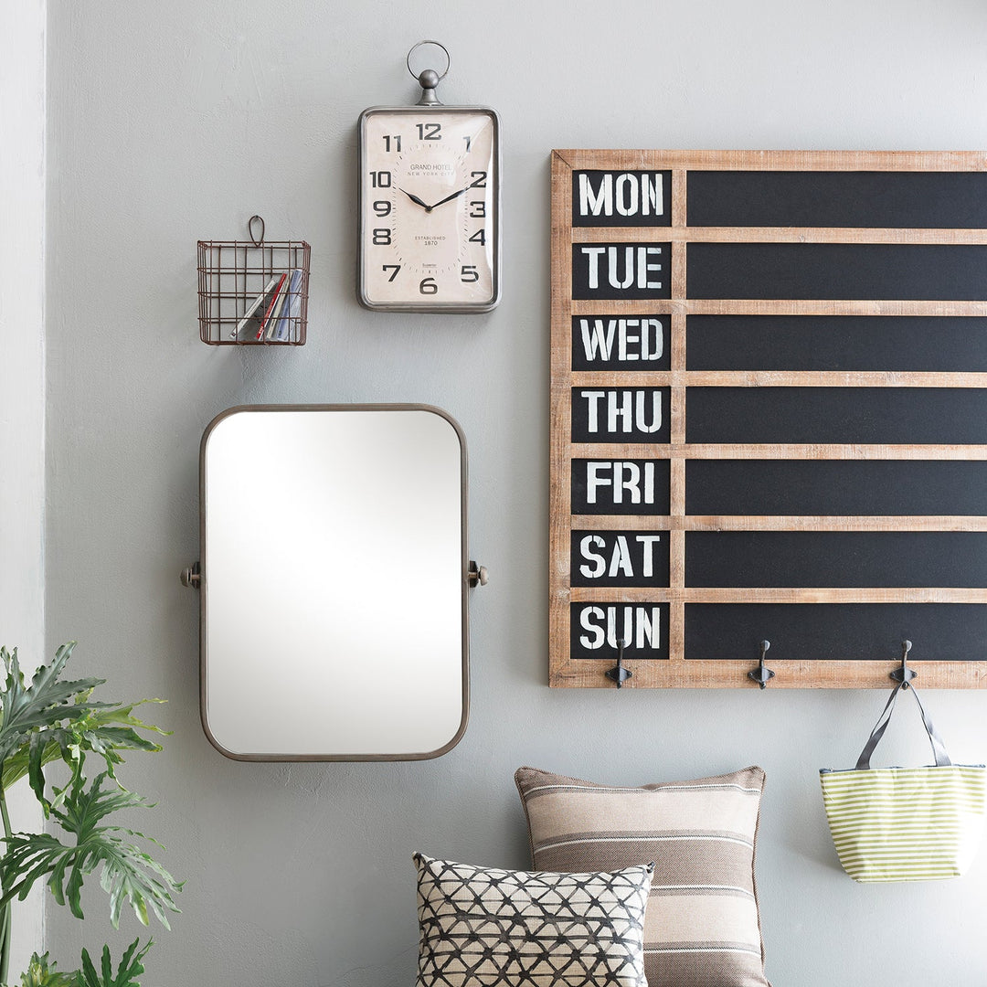 Wall decor with a mirror, vintage clock, weekly planner board, and cozy pillows, creating a functional and stylish accent for modern living spaces.