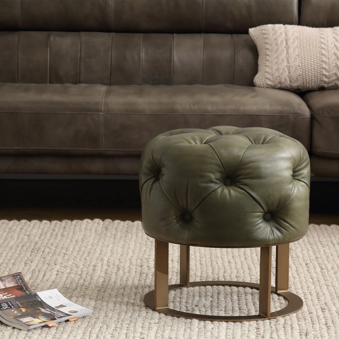 Boho-style ottoman with geometric patterns, topped with a textured cushion, paired with a vintage chair, adding comfort and charm to the space.