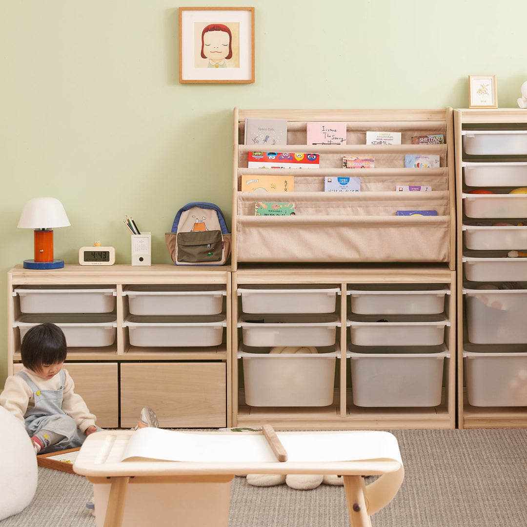 Versatile plastic storage unit with stackable bins and a fabric book organizer, ideal for creating a tidy and functional kids’ room.