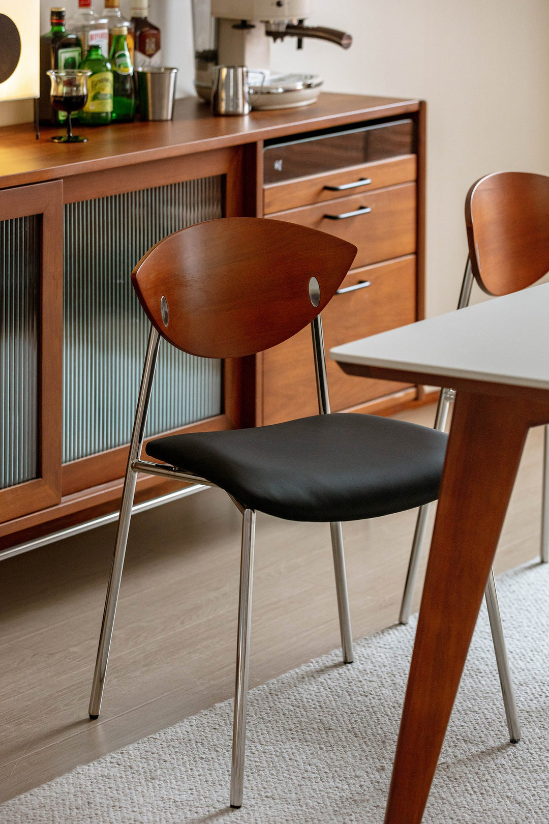 PU leather dining chair with wooden backrest and metal legs, styled for Singapore dining rooms, HDB flats, condos, and modern apartments.