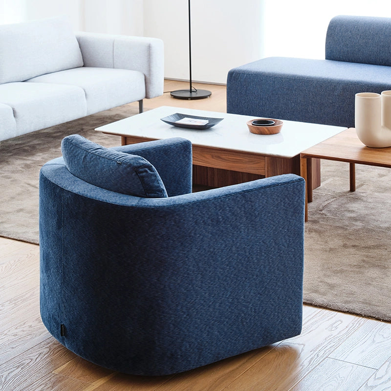 Loft Home revolving sofa chair with a curved backrest and navy blue fabric, designed for comfort and flexibility in modern living rooms in the Revolving Sofa Chairs collection.