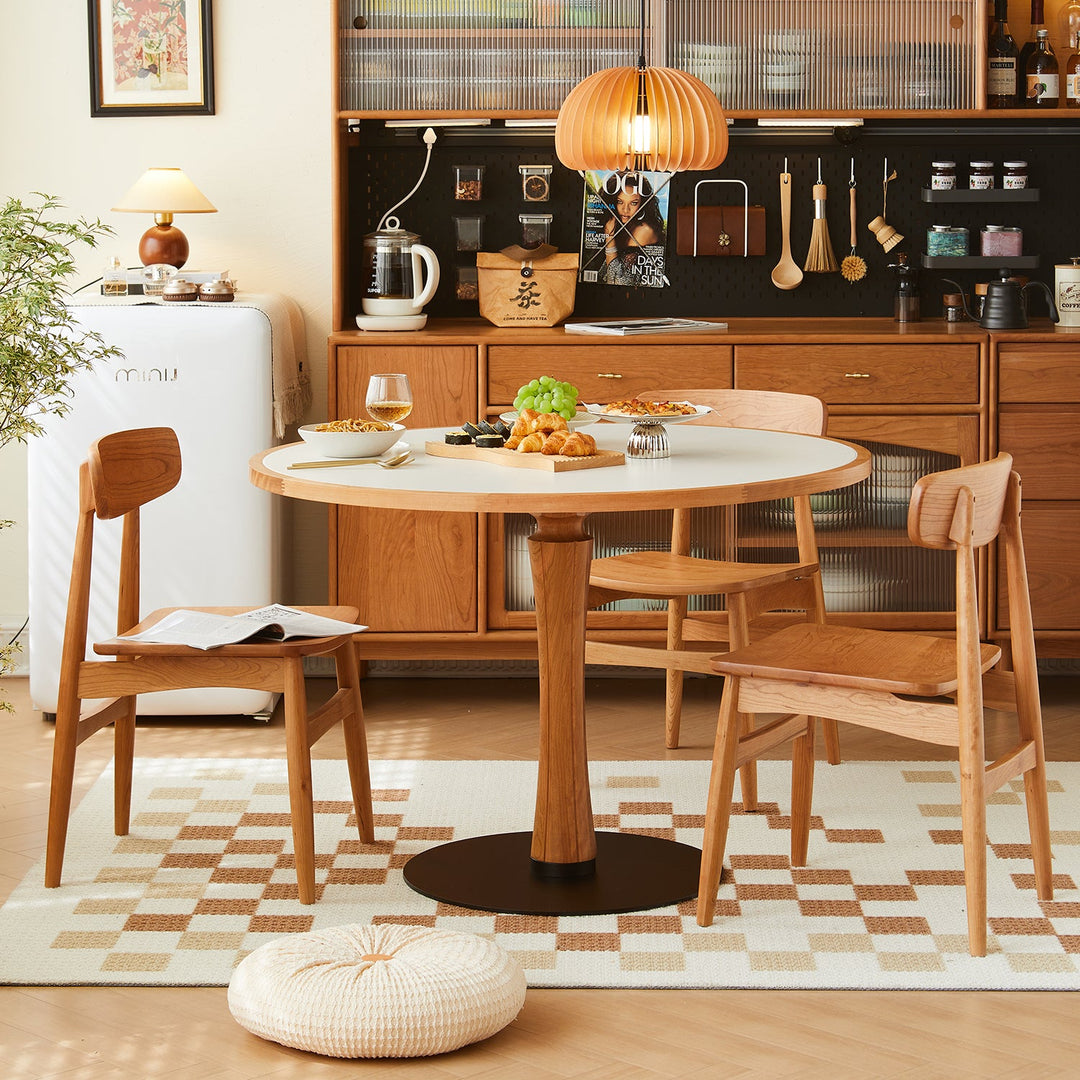 Loft Home round dining table collection, showcasing a modern wood and metal round dining table with matching chairs, styled in a warm and inviting kitchen setting for cozy gatherings.