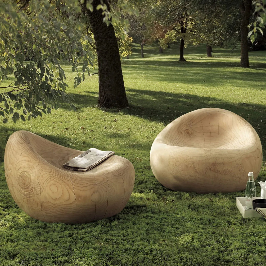 Cover picture for Loft Home's Rustic Sofas collection: unique wooden chairs set in a lush, green outdoor setting, creating a natural and serene ambiance.