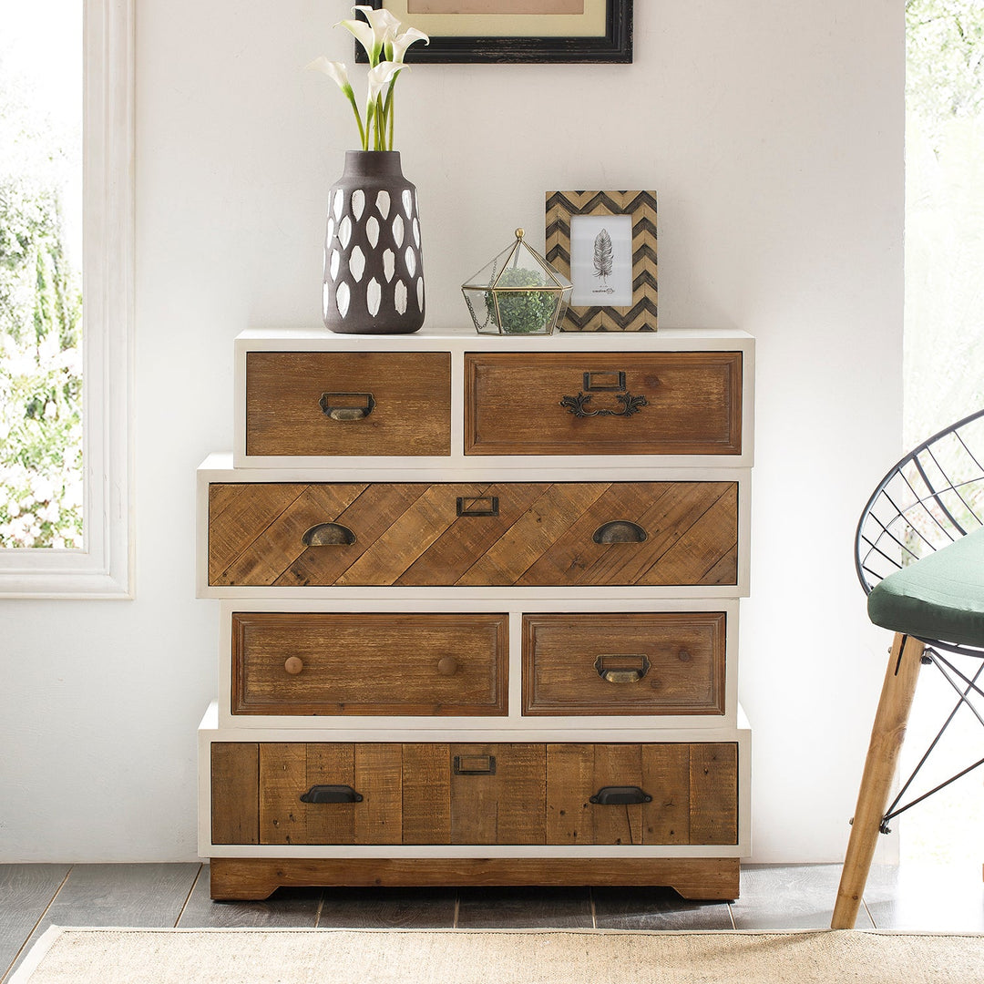 Loft Home rustic storage cabinet with natural wood finish and mixed handle designs, styled with decorative vases and photo frames, enhancing a charming countryside-inspired interior.