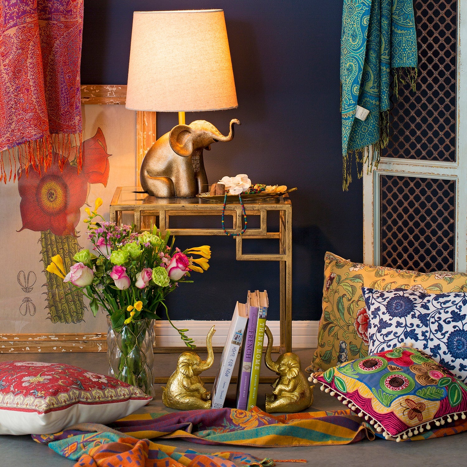 Loft Home vibrant display featuring colorful textiles, floral accents, and gold decor elements, representing the Sales by Type collection for diverse home styling options.