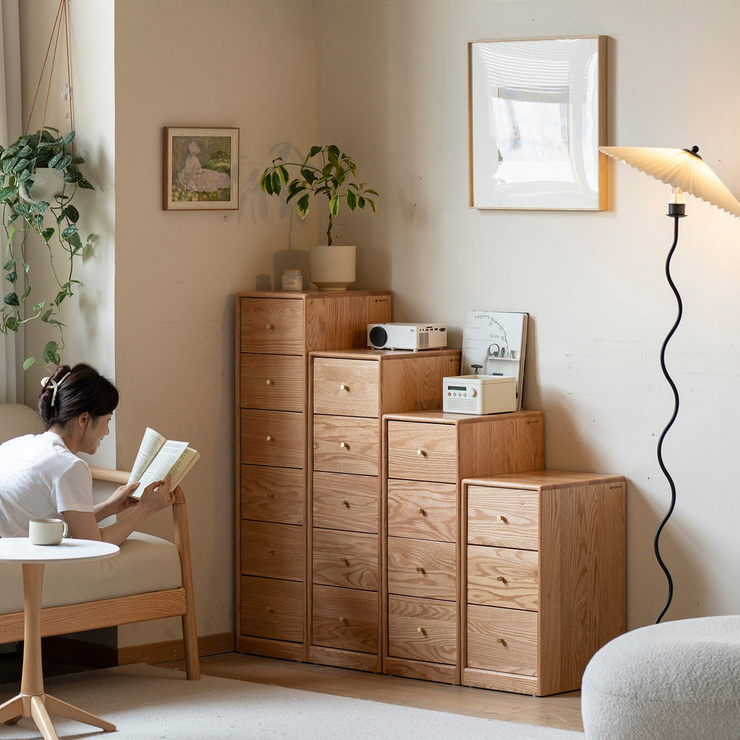 Scandinavian chest of drawers in natural wood finish, featuring varying heights for versatile storage, blending minimalist design with functional elegance.