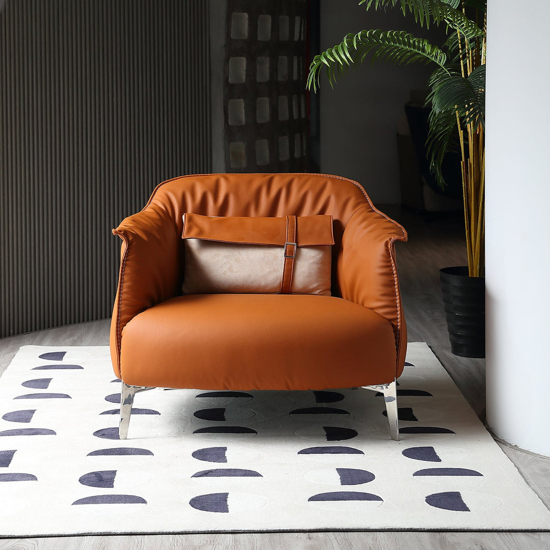 Modern PU leather 1-seater sofa in a bold brown tone, featuring sleek metallic legs and paired with a geometric rug for a stylish accent.