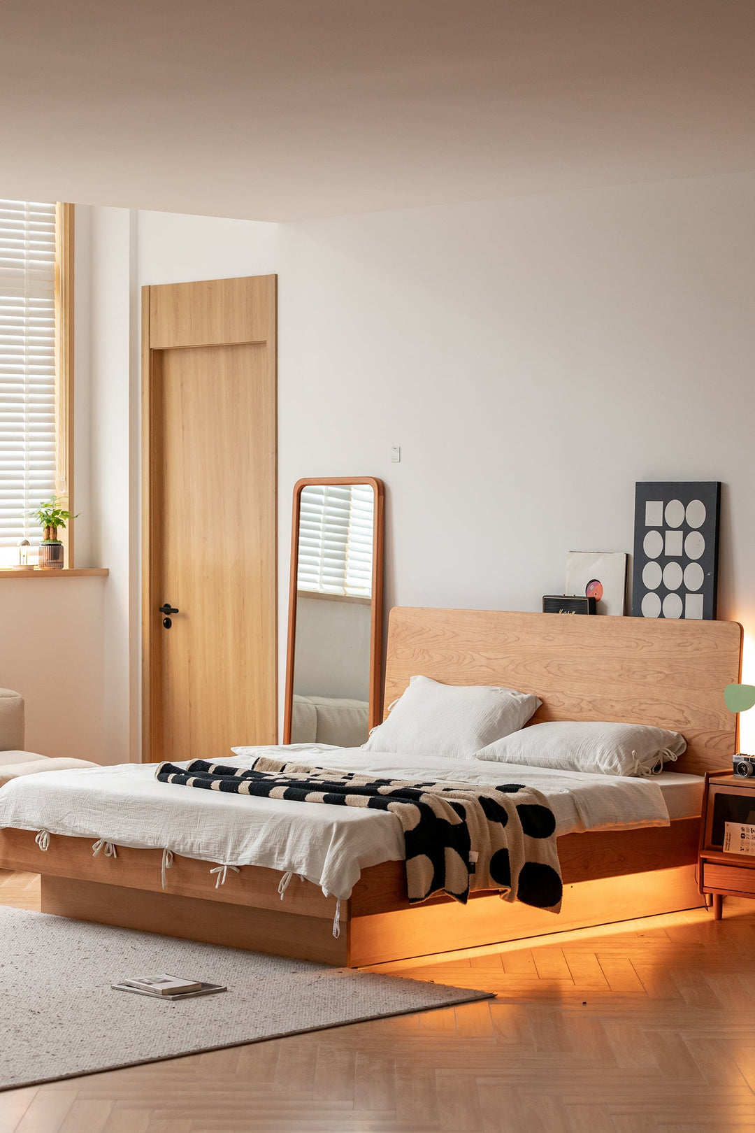 Scandinavian wooden bed with minimalist headboard and under-bed lighting, styled with cozy bedding and modern decor, ideal for a serene bedroom setup.