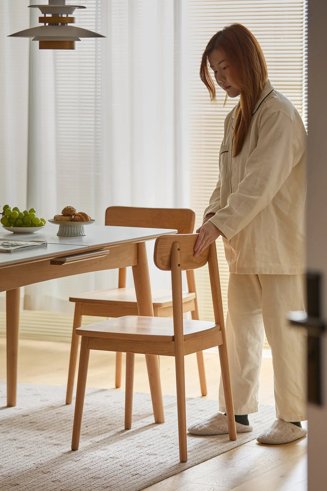 Scandinavian-style solid wood dining chairs in light finish, shown in a minimalist setting with natural light, adding warmth and simplicity to modern interiors.