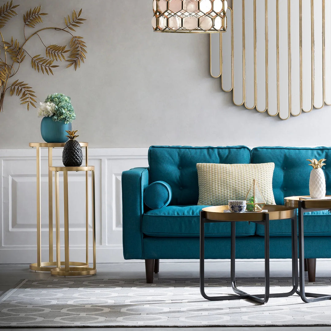 Scandinavian-style living room with a blue sofa, modern side tables, and decorative wall accents, linking to Loft Home's Scandinavian sofas collection.