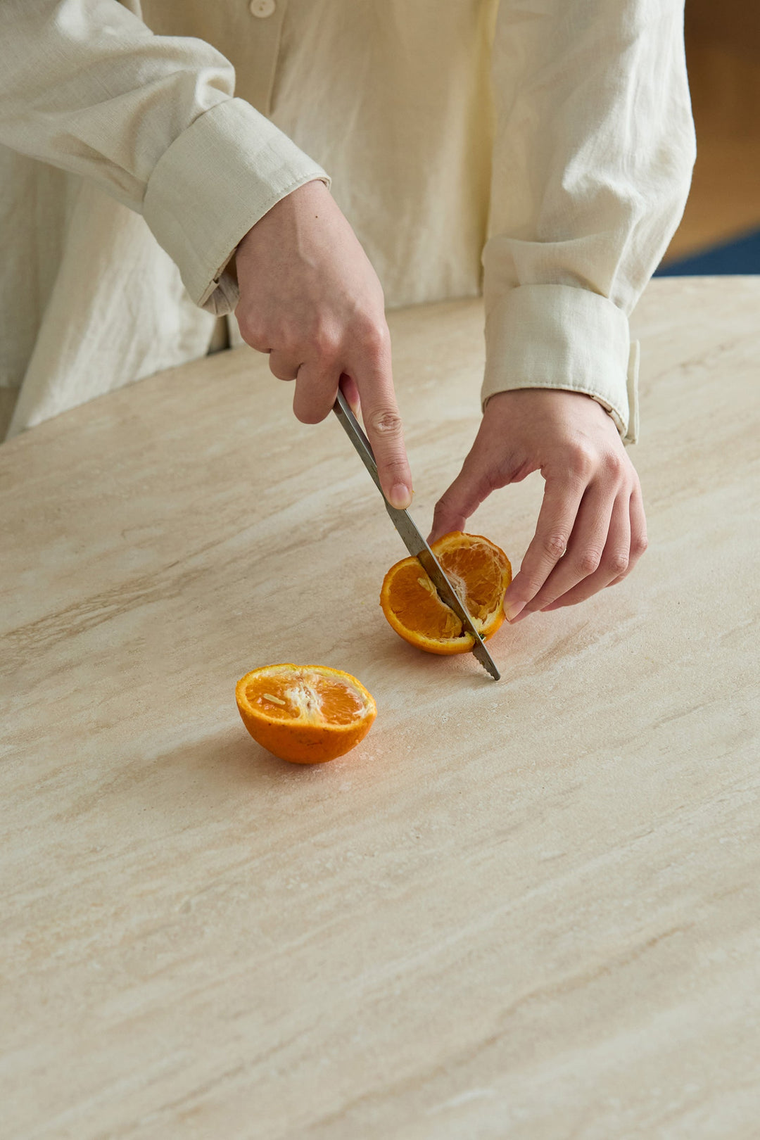 Scratch-resistant table surface with fruit being cut, designed for durable daily use in Singapore HDB flats, condos, and dining spaces.