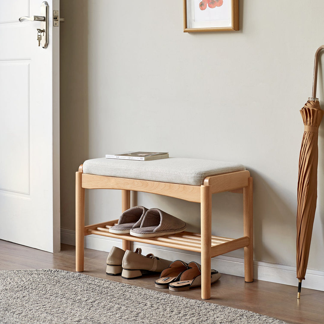 Wooden shoe bench with a soft cushioned seat and storage rack, ideal for organizing footwear and enhancing entryway functionality.