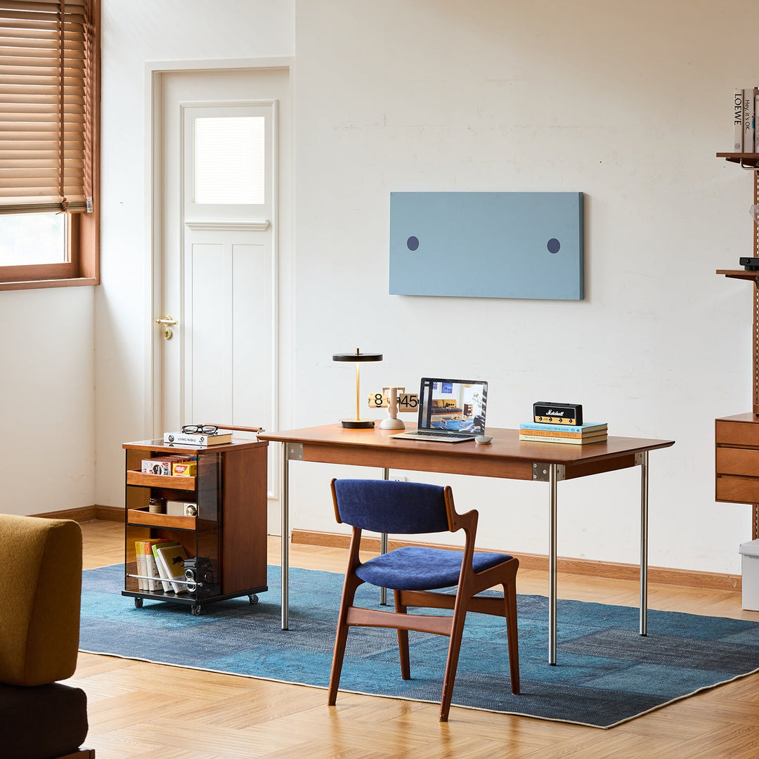 Modern home office setup with wooden desk, blue dining chair and curated decor, inspiring stylish furniture combinations for Singapore living spaces.