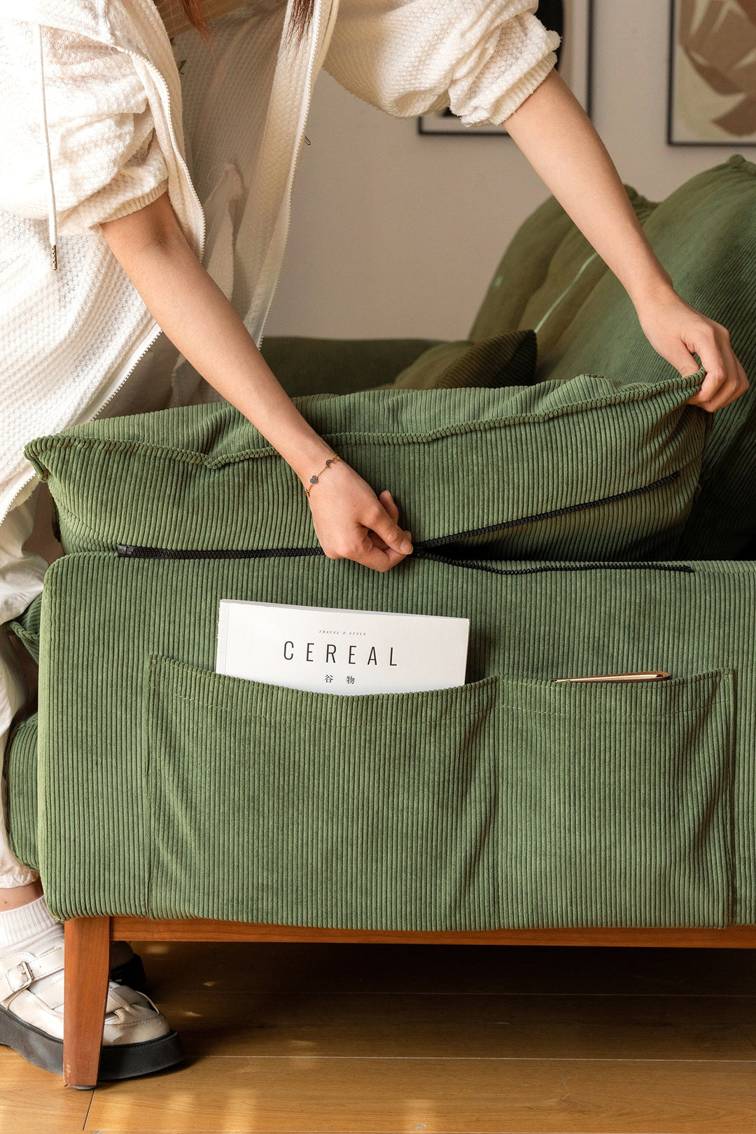 Modern green fabric sofa with storage pockets and zip design, ideal for compact Singapore homes, HDB flats, and condos.