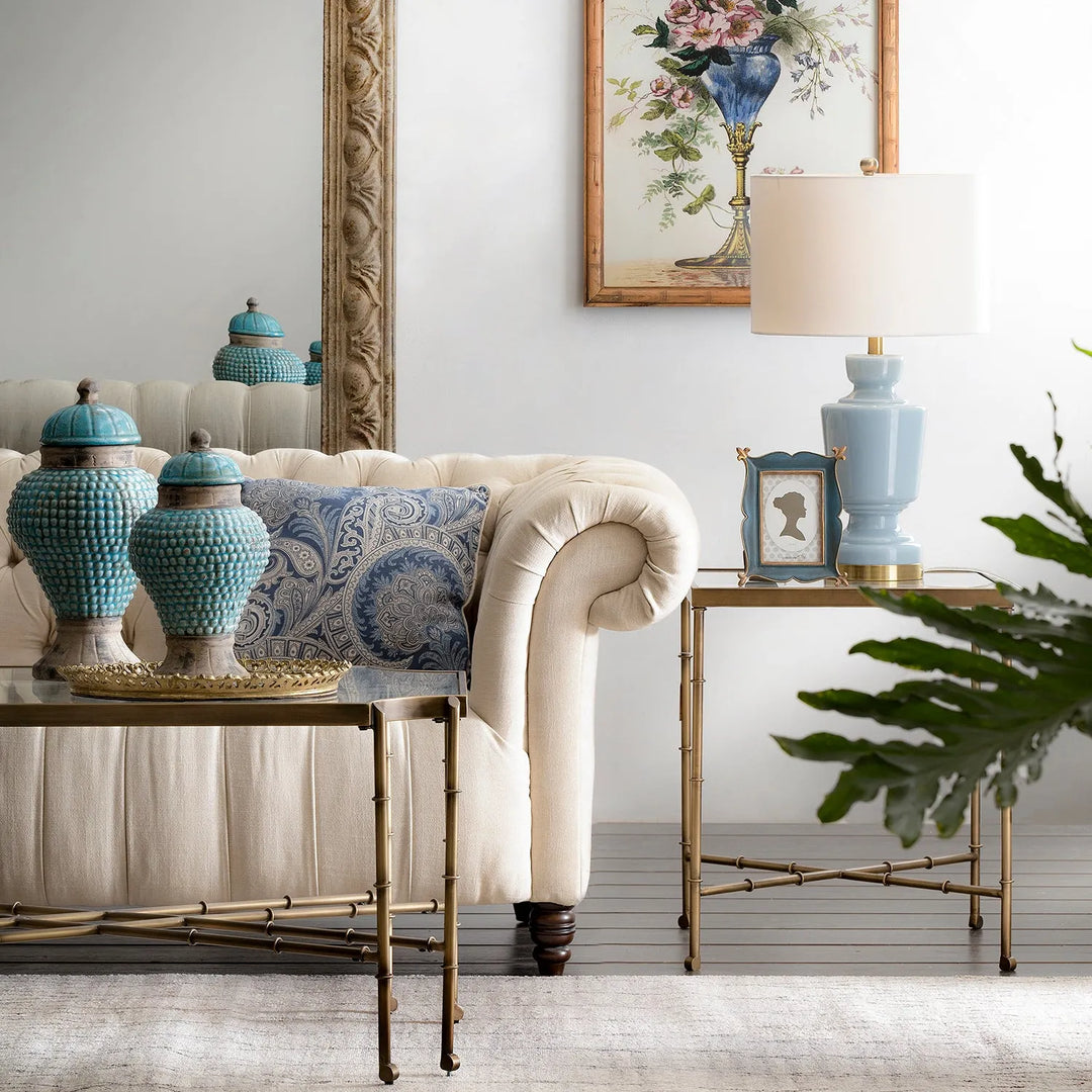 Cover picture for Loft Home's Sofas by Type collection: elegant living room with a beige chesterfield sofa, blue ceramic vases, and a matching lamp on stylish side tables.