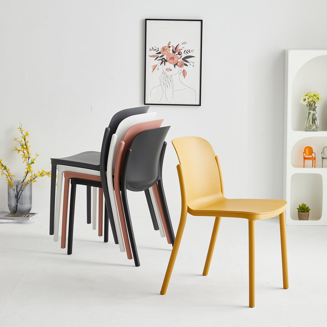 Modern stackable dining chairs in vibrant colors, made of lightweight durable plastic, perfect for space-saving and versatile seating in contemporary dining areas.