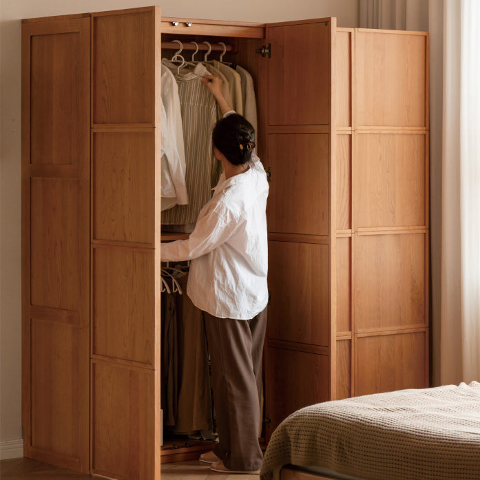 Classic wooden wardrobe with swing doors, featuring spacious interior compartments and a timeless design, perfect for organizing clothes in elegant bedrooms.