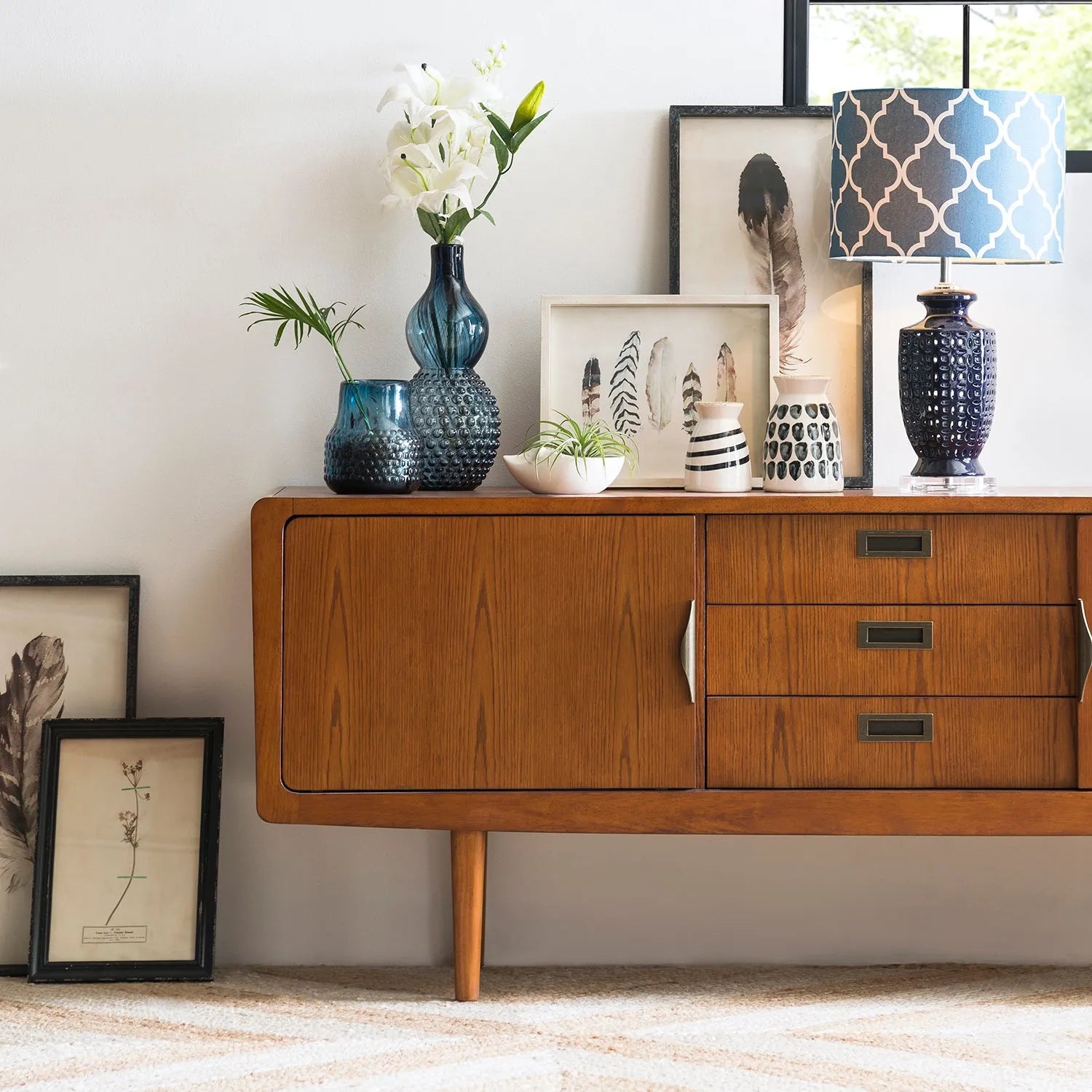 Modern living room with a sleek wooden TV console featuring clean lines and a minimalist design, complemented by contemporary decor, linking to Loft Home's TV consoles by material collection.