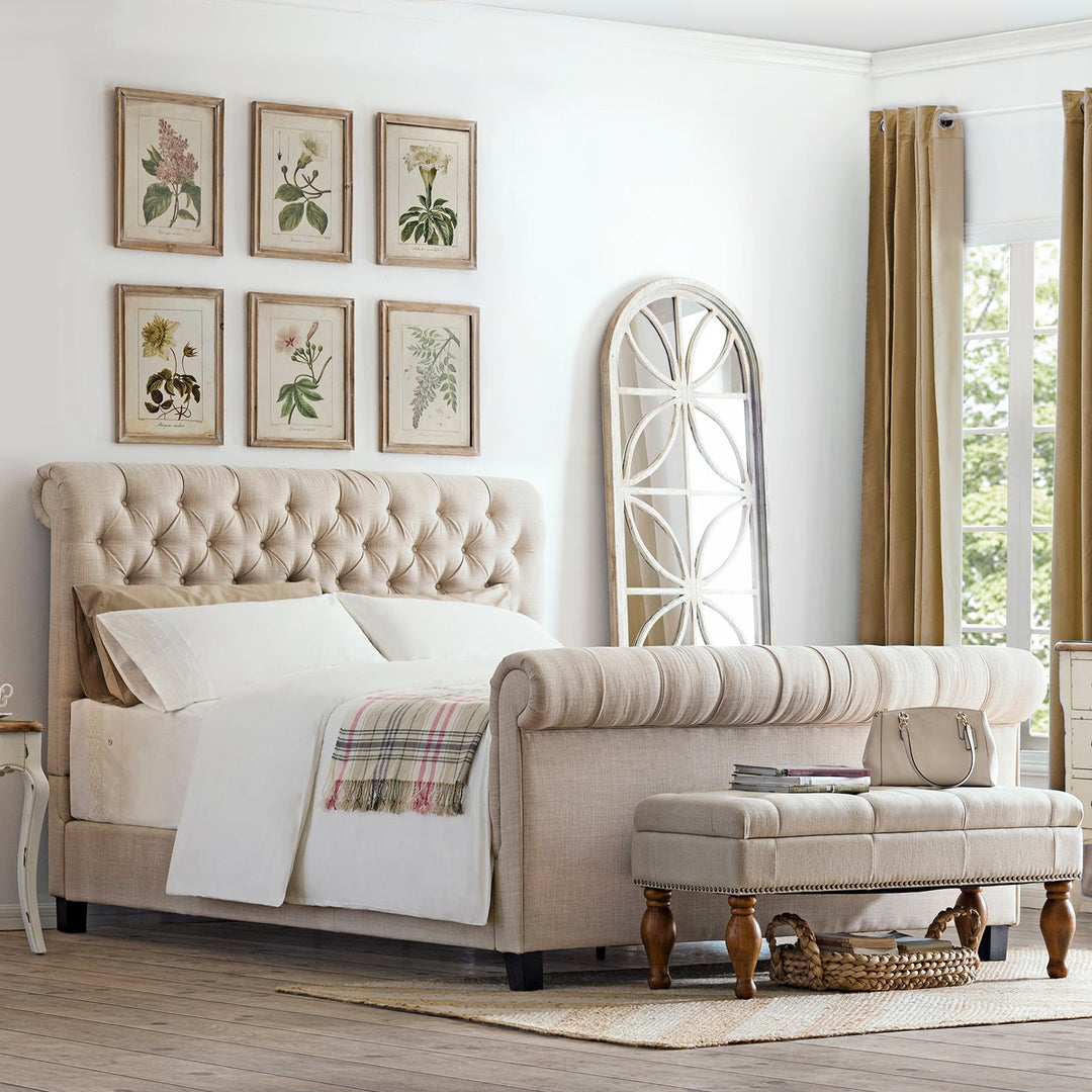 Vintage-style bedroom with a tufted bed frame, botanical wall art, an upholstered bench, and rustic decor, creating a cozy and timeless ambiance.