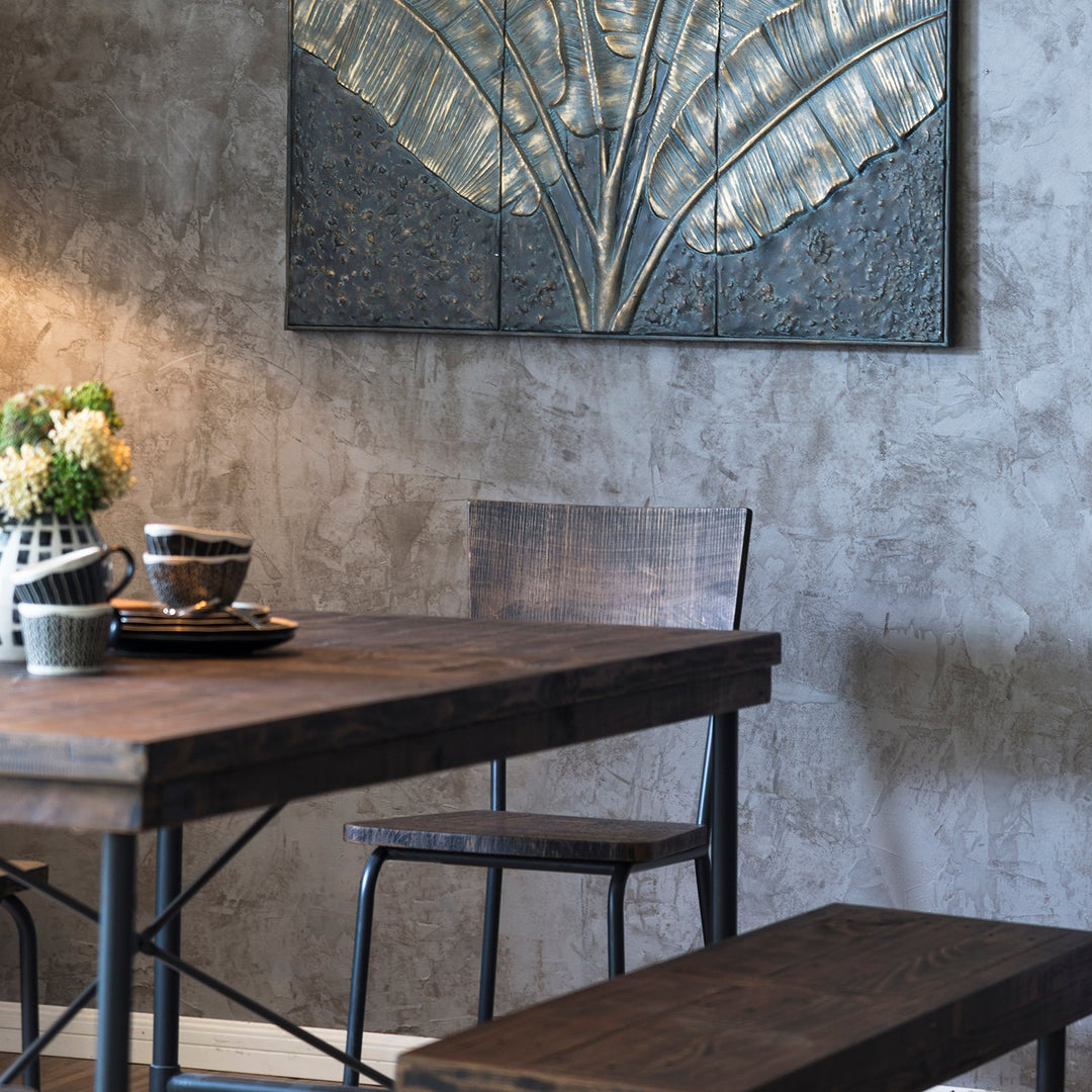 Loft Home Vintage Style Collection - rustic dining table with industrial metal chairs and banana leaf wall art