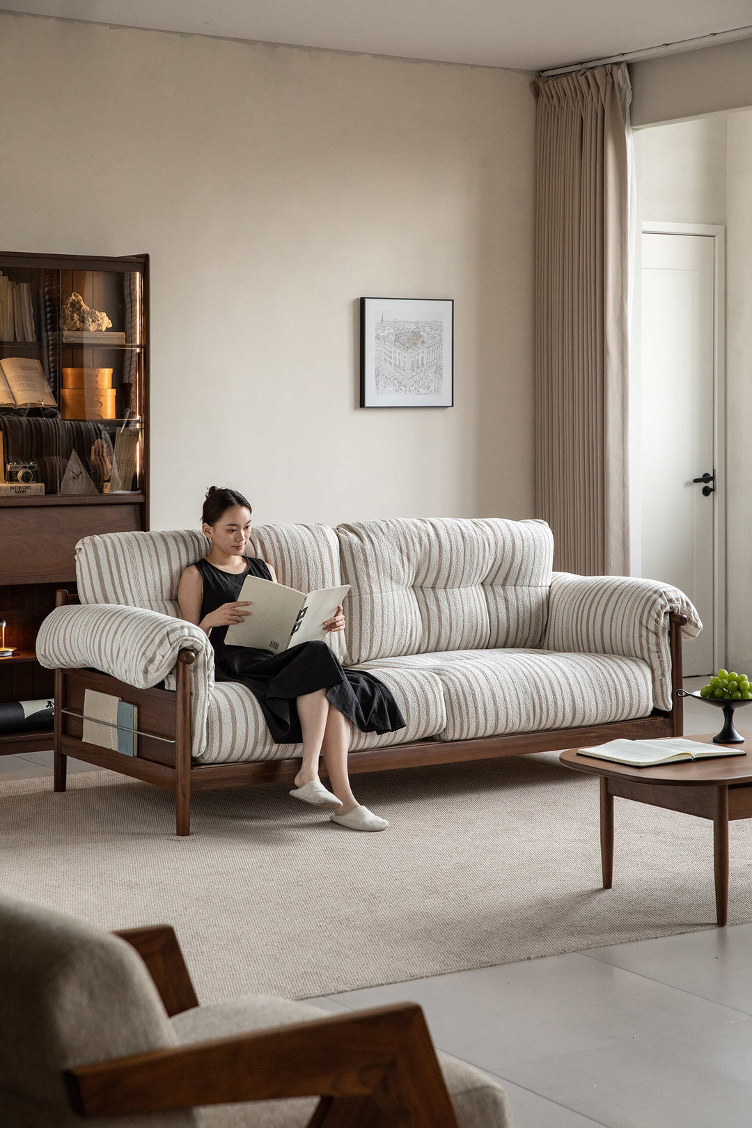 Wabi-sabi premium wooden-frame sofa with soft striped cushions, styled in a calm modern living room, offering relaxed comfort to Singapore homes.