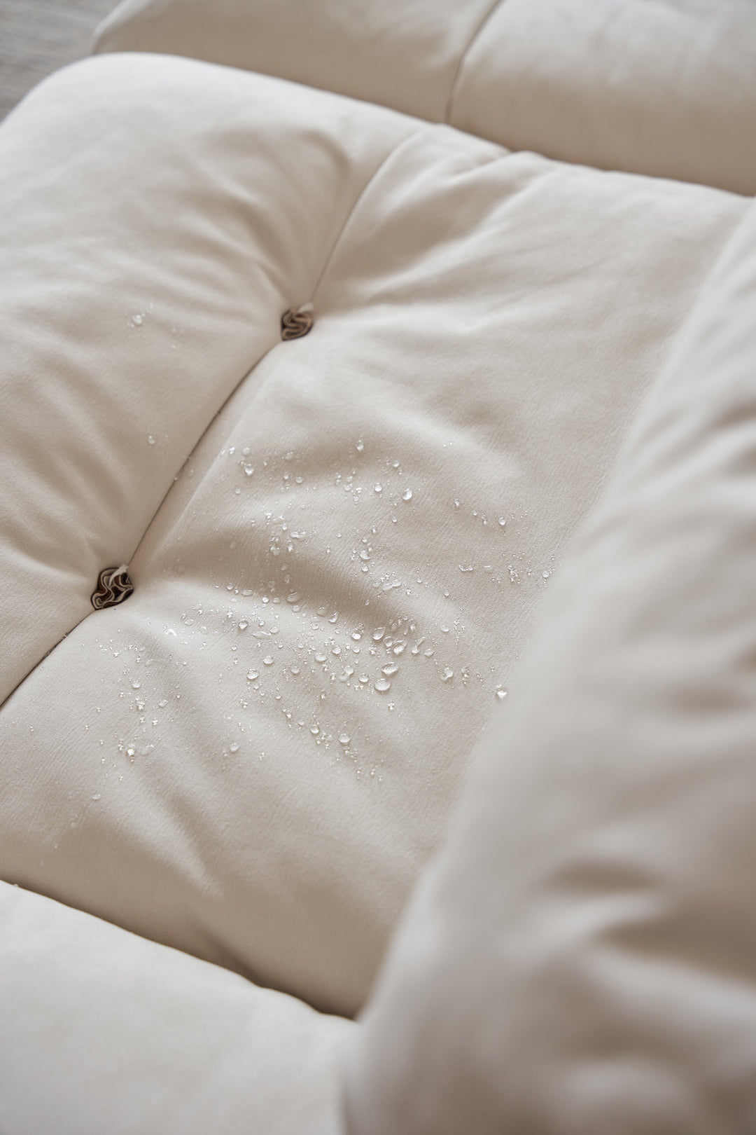 Waterproof fabric sofa with water droplets, designed for easy cleaning and everyday comfort in Singapore homes, HDB flats, and condos.