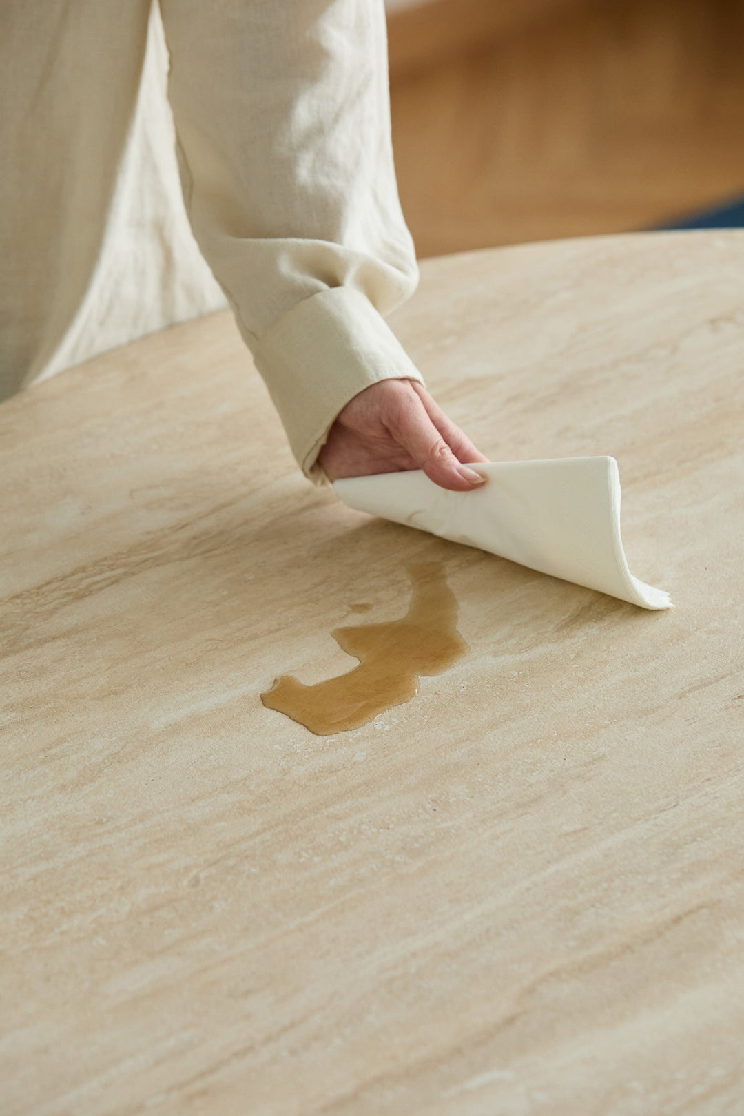 Waterproof table surface being wiped clean, designed for easy-care dining, HDB flats, condos, and everyday Singapore homes.