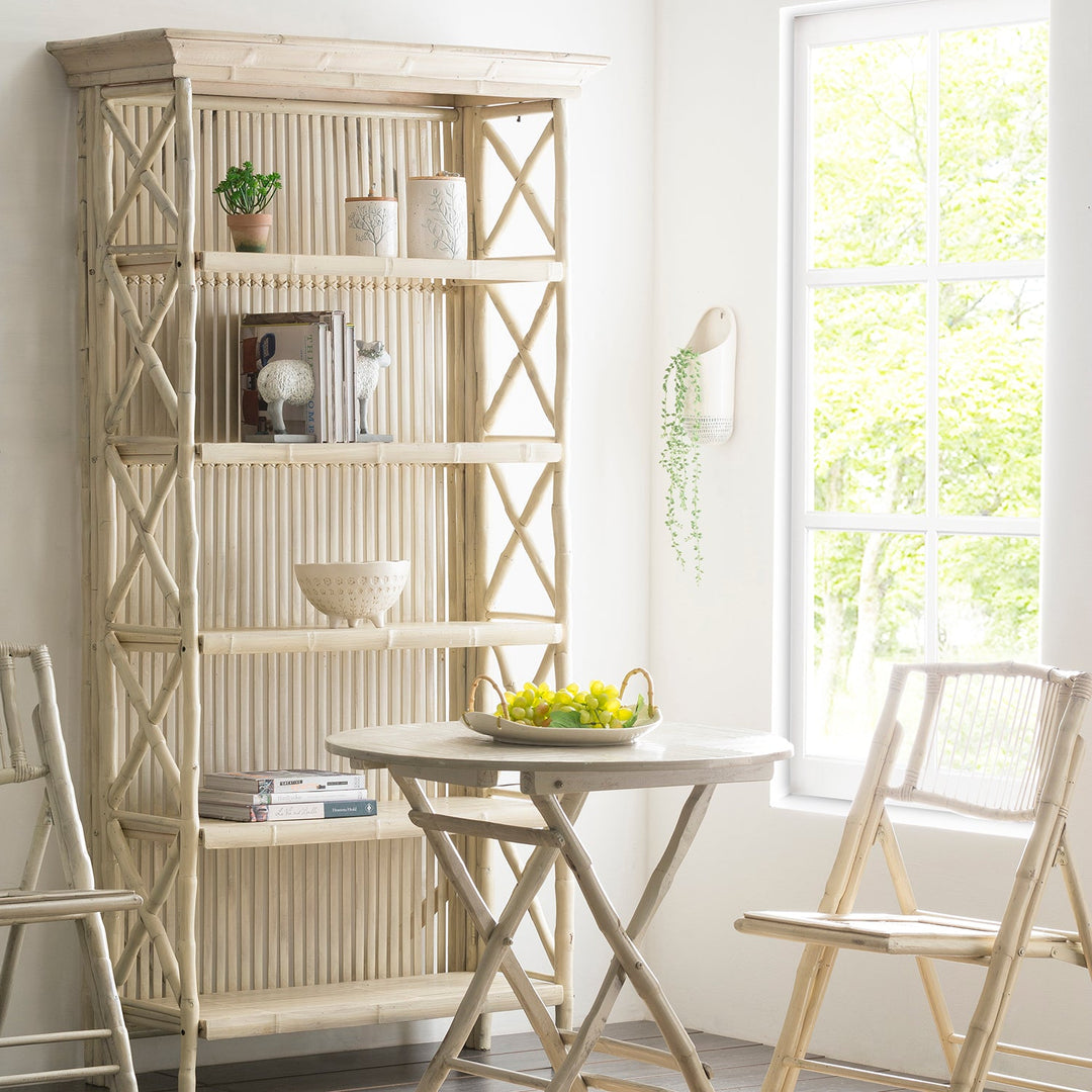 Light wooden shelf with open storage, styled with decor items and paired with a matching table and chairs, ideal for bright, cozy interiors.