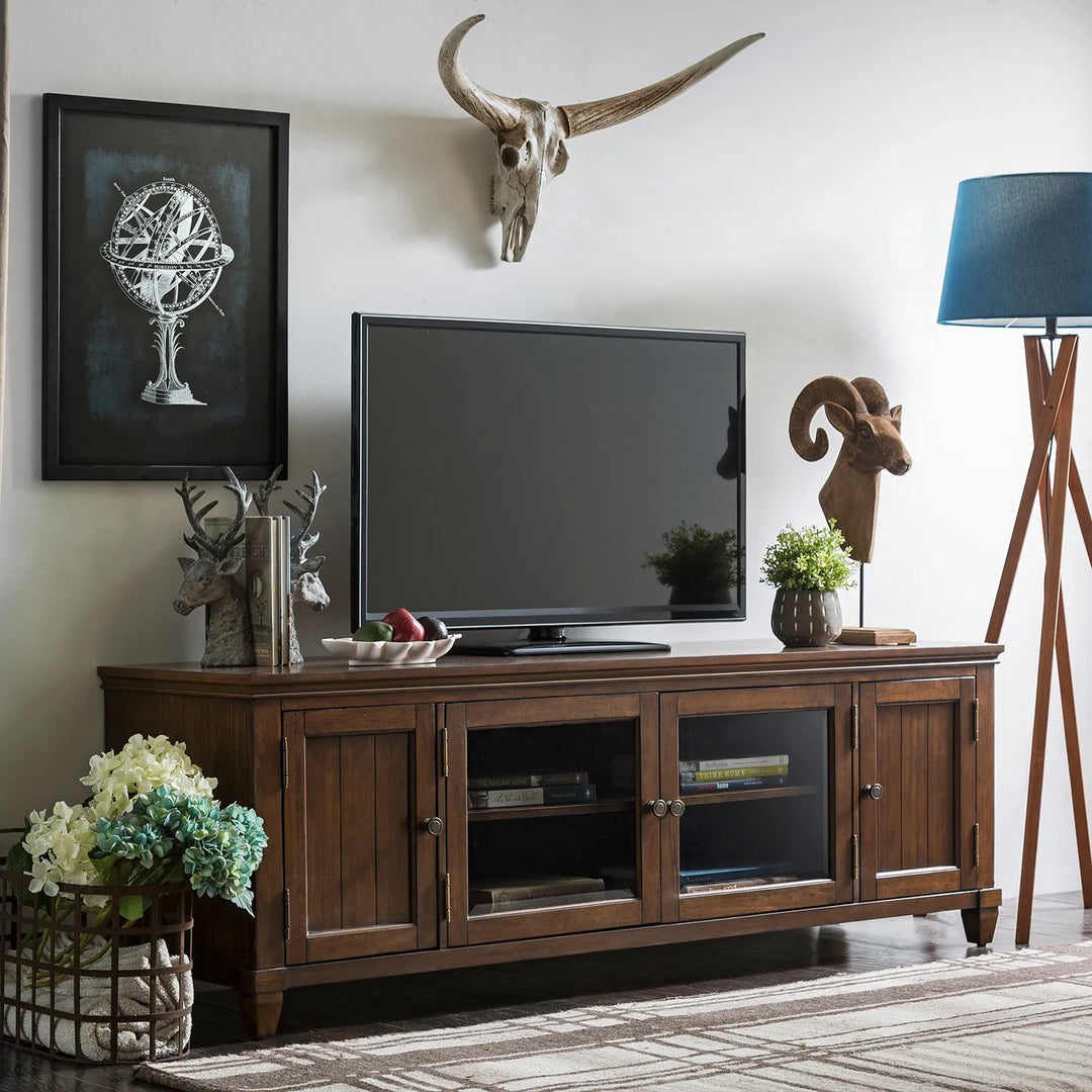 "Rustic living room featuring a wooden TV console with ample storage, animal skull wall decor, and modern accents, linking to Loft Home's wooden TV consoles collection.