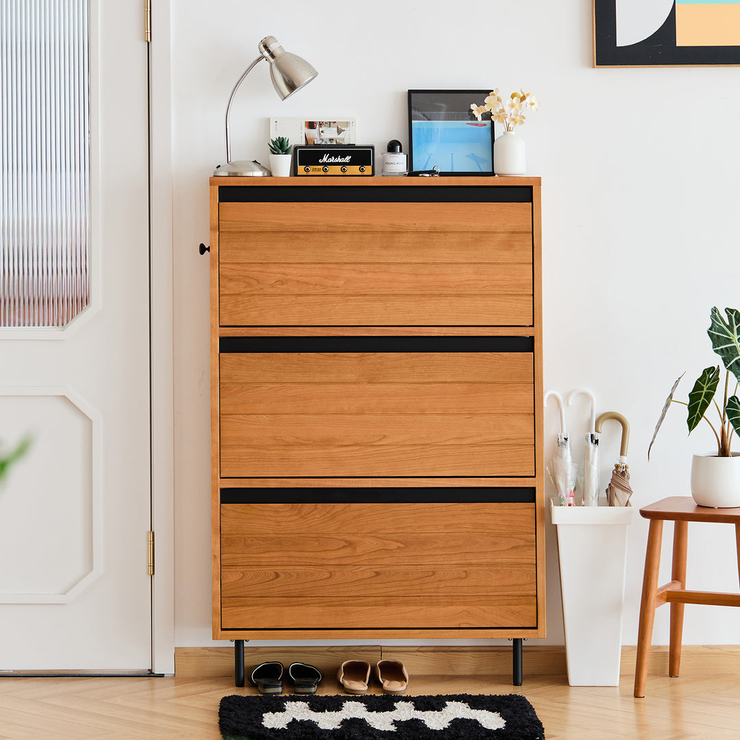 Scandinavian cherry wood shoe cabinet corner in panoramic view.