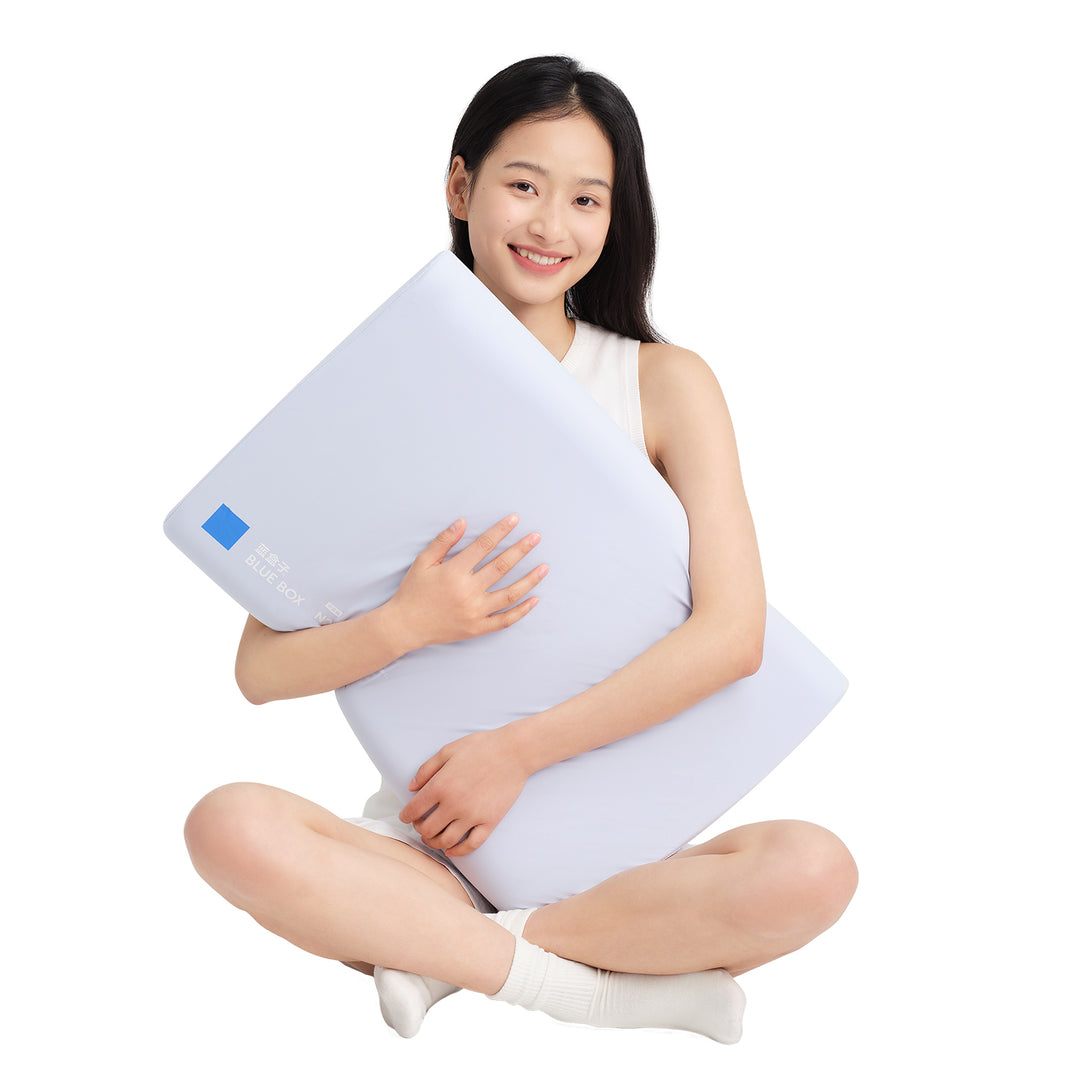 Woman holding a white pillow with a blue logo on a white background
