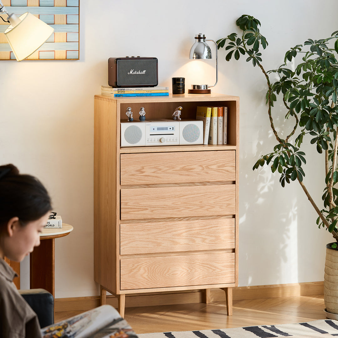 Scandinavian oak wood chest of 5 drawers floating light in still life.