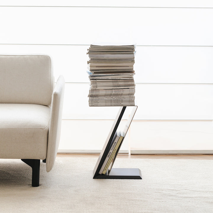 Minimalist stainless steel side table zig in still life.