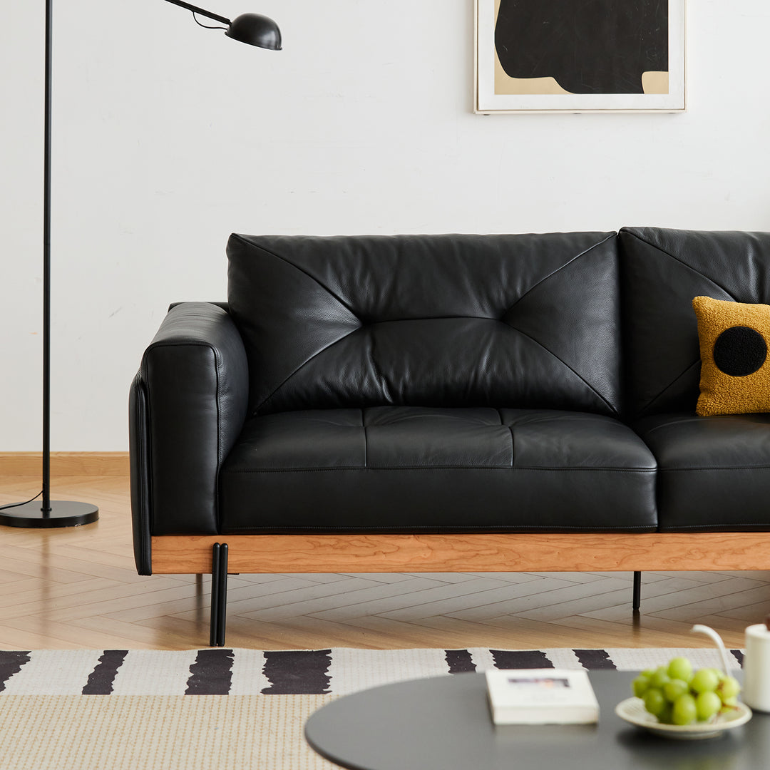 Scandinavian microfiber leather 3 seater sofa black in still life.
