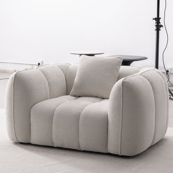 Cream mixed weave fabric 1 seater sofa puddy with context.