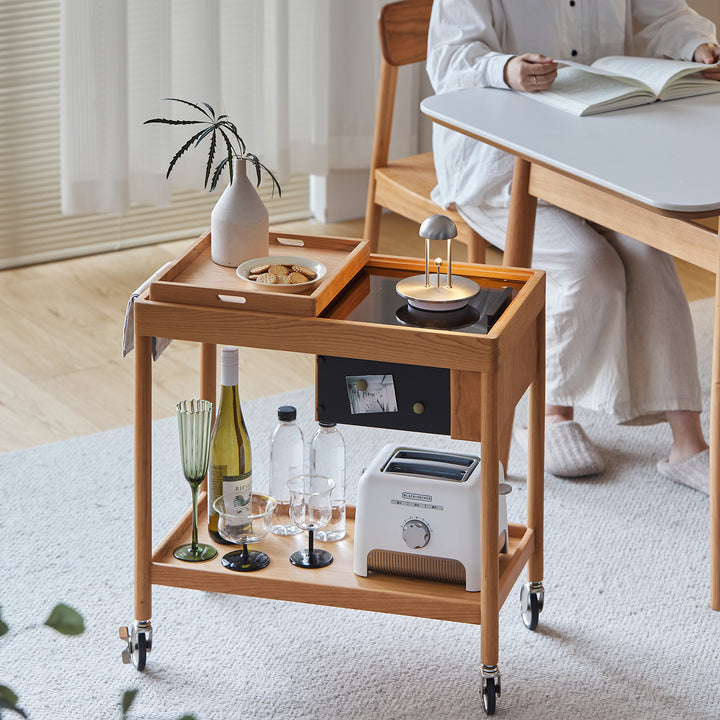 Scandinavian cherry wood wheeled trolley side table pocket in still life.