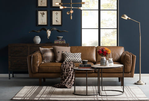 Modern living room with a brown three-seater sofa and decorative pillows. Explore 3-seater sofas at Loft Home Furniture.