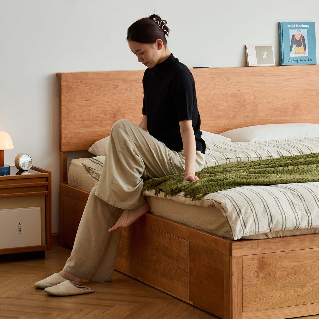 Scandinavian cherry wood lift-up storage bed with drawer kangaroo in panoramic view.