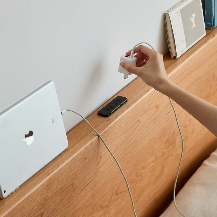 Scandinavian cherry wood lift-up storage bed with drawer kangaroo in still life.
