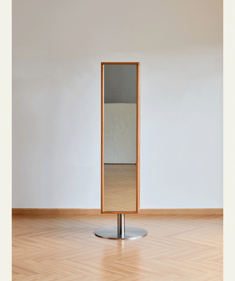 Scandinavian cherry wood revolving shelf with mirror timeless in still life.