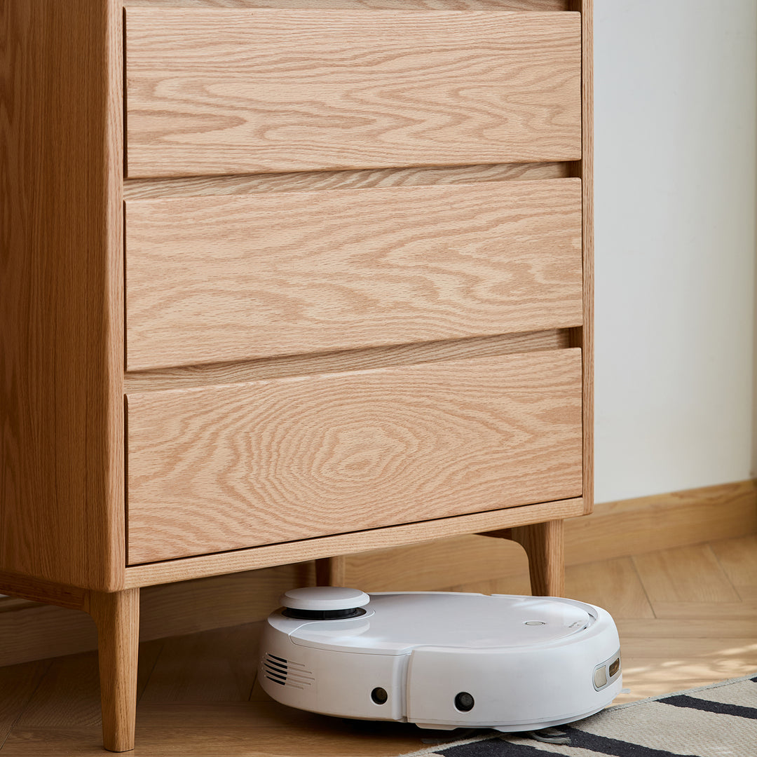 Scandinavian oak wood chest of 5 drawers floating light in real life style.